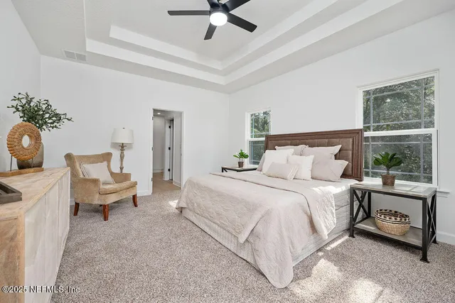 a spacious bedroom with a bed and window