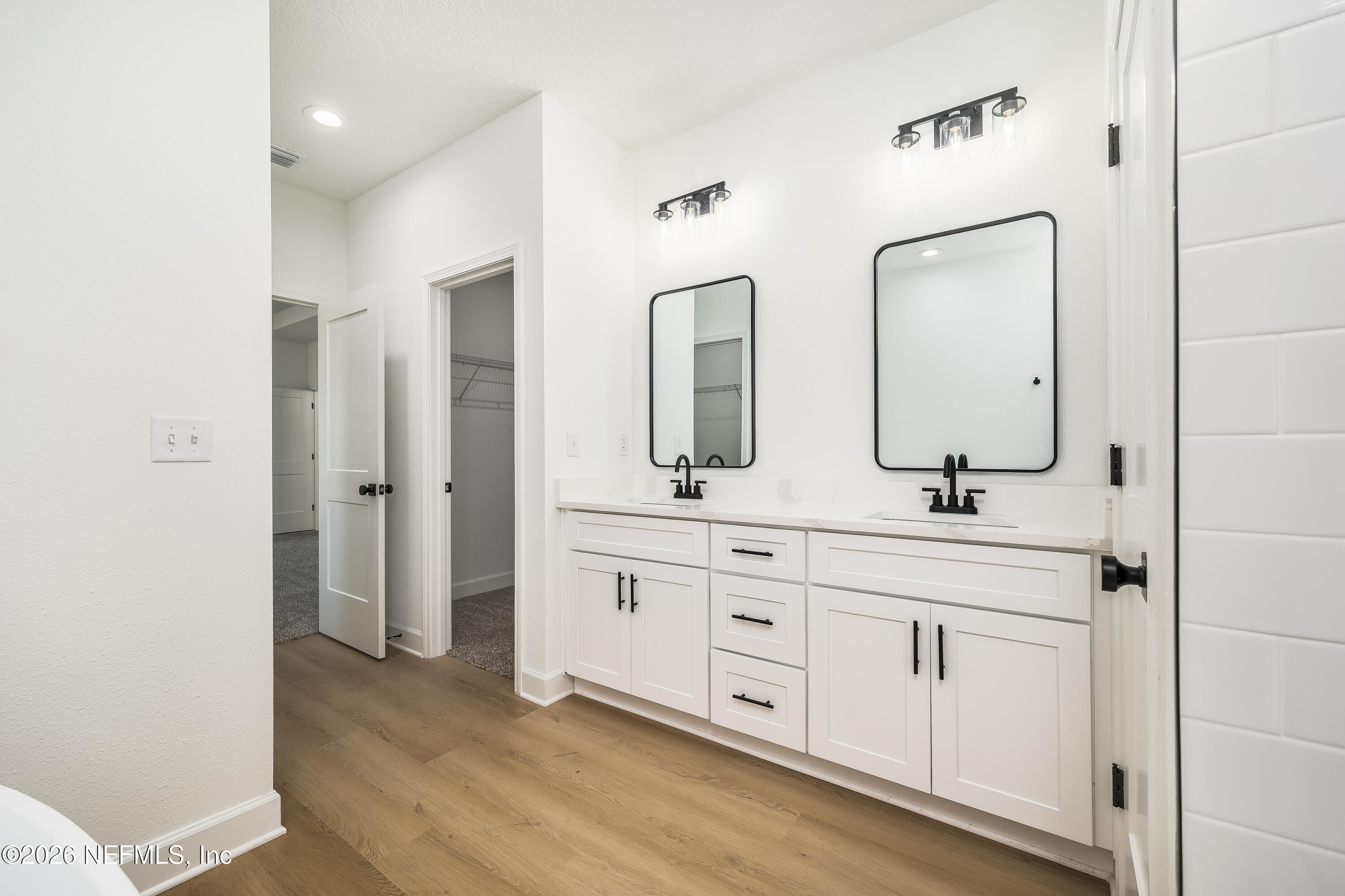 4455 Southeast 3rd Place Keystone Heights, FL 32656 - Photo 8 of 25 a spacious bathroom with a double vanity sink mirror and