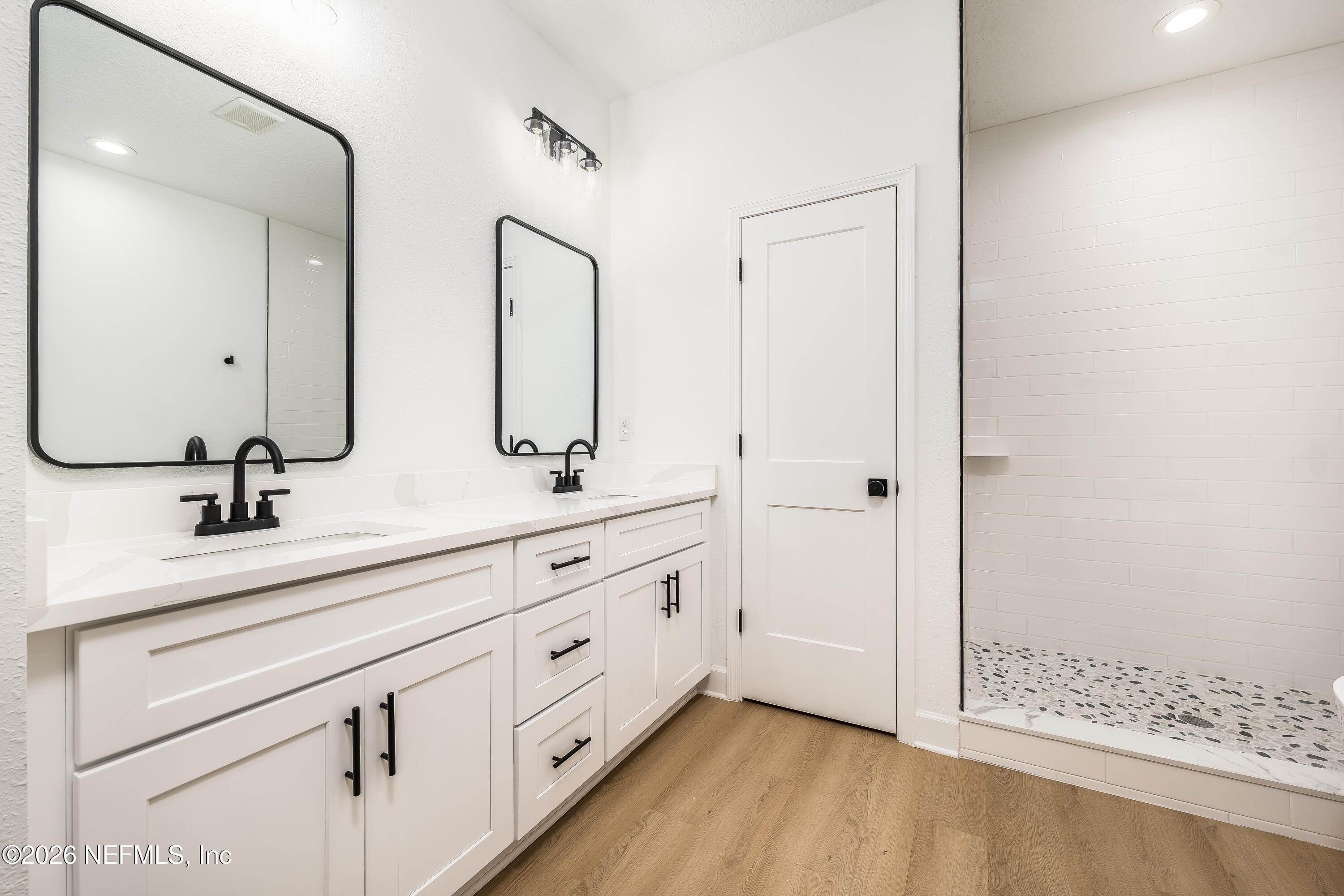 4455 Southeast 3rd Place Keystone Heights, FL 32656 - Photo 9 of 25 a bathroom with double sink and a mirror