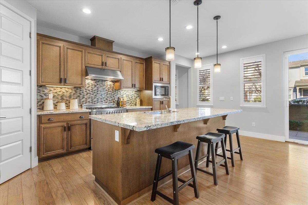 406 Mosley Avenue Alameda, CA 94501 - Photo 14 of 60 a kitchen with stainless steel appliances granite countertop wooden floor window and cabinets