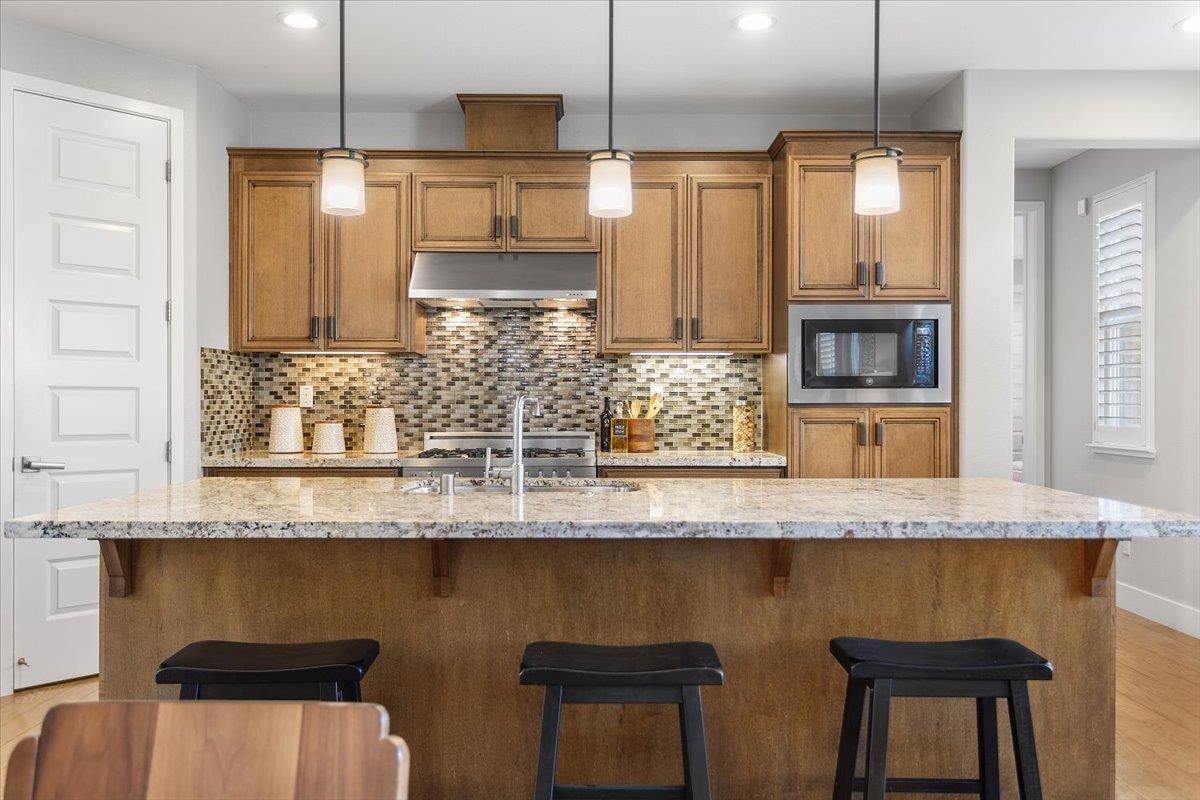406 Mosley Avenue Alameda, CA 94501 - Photo 17 of 60 a kitchen with stainless steel appliances granite countertop a sink and a refrigerator