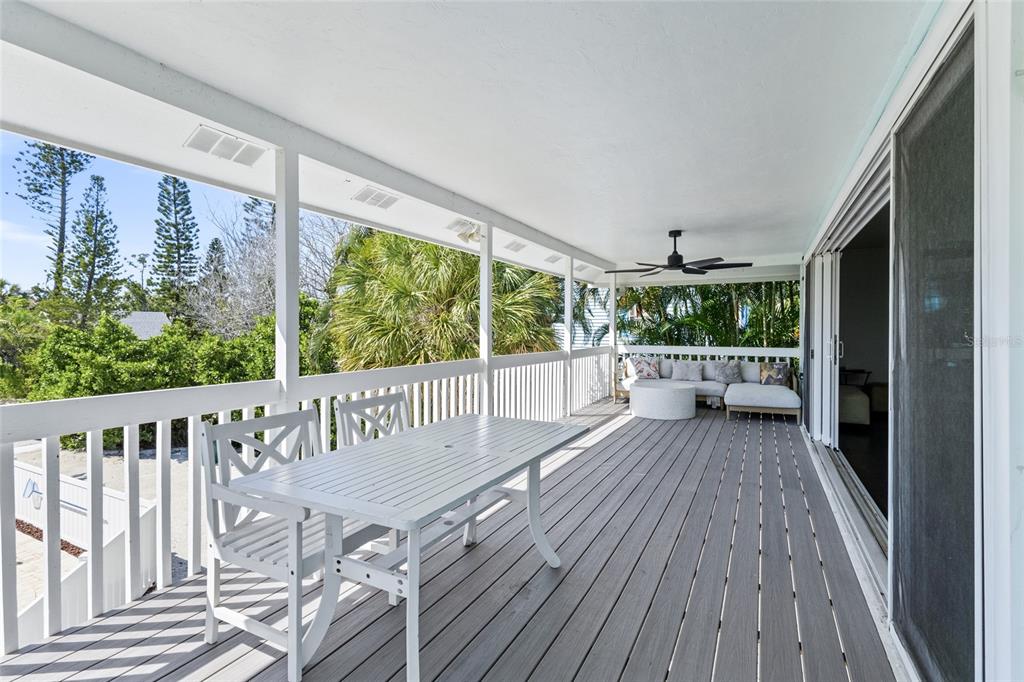315 Spring Avenue Anna Maria, FL 34216 - Photo 24 of 63 a view of balcony with wooden floor and outdoor seating