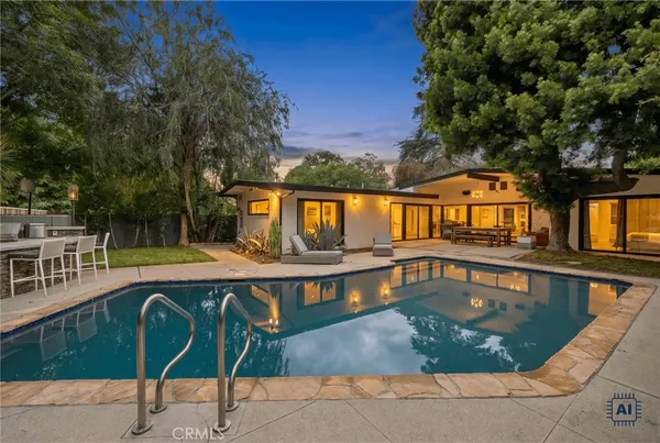 swimming pool view with a seating space