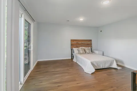 a view of a workspace with furniture and wooden floor