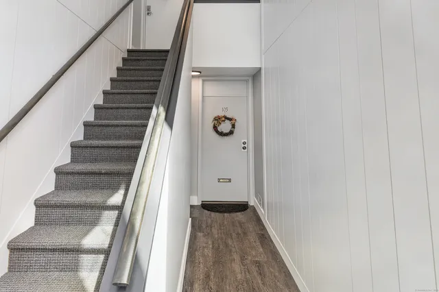 a view of a hallway with wooden floor and entryway