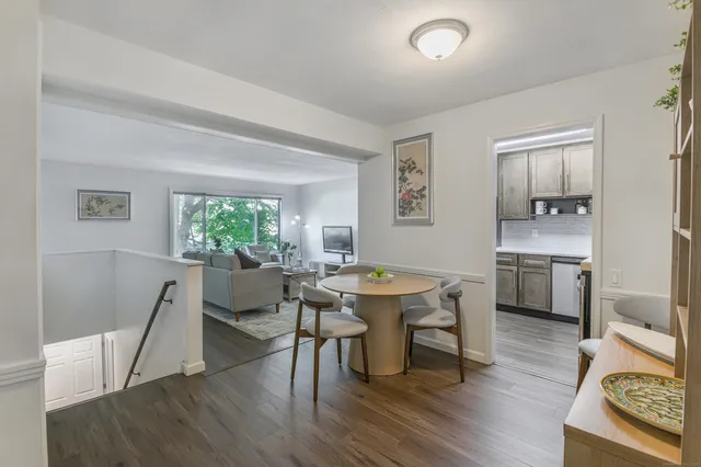 a view of a dining room with furniture and a wooden floor