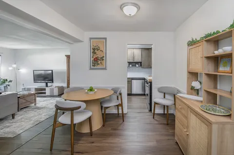 a view of a dining room with furniture and wooden floor
