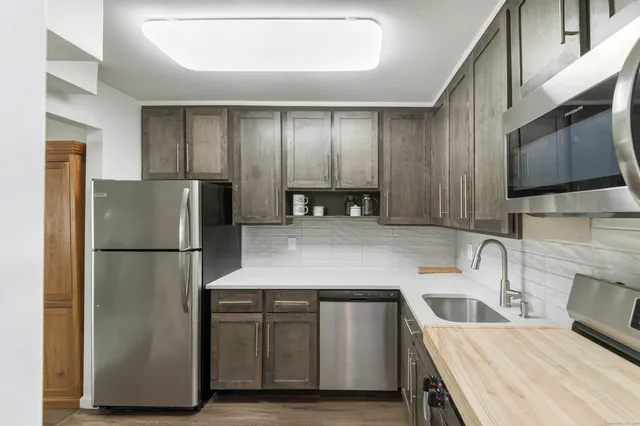 a kitchen with a refrigerator sink and stove