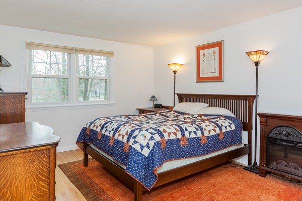 1053 Frank Smith Road Longmeadow, MA 01106 - Photo 24 of 30 a bedroom with a bed lamp and a window