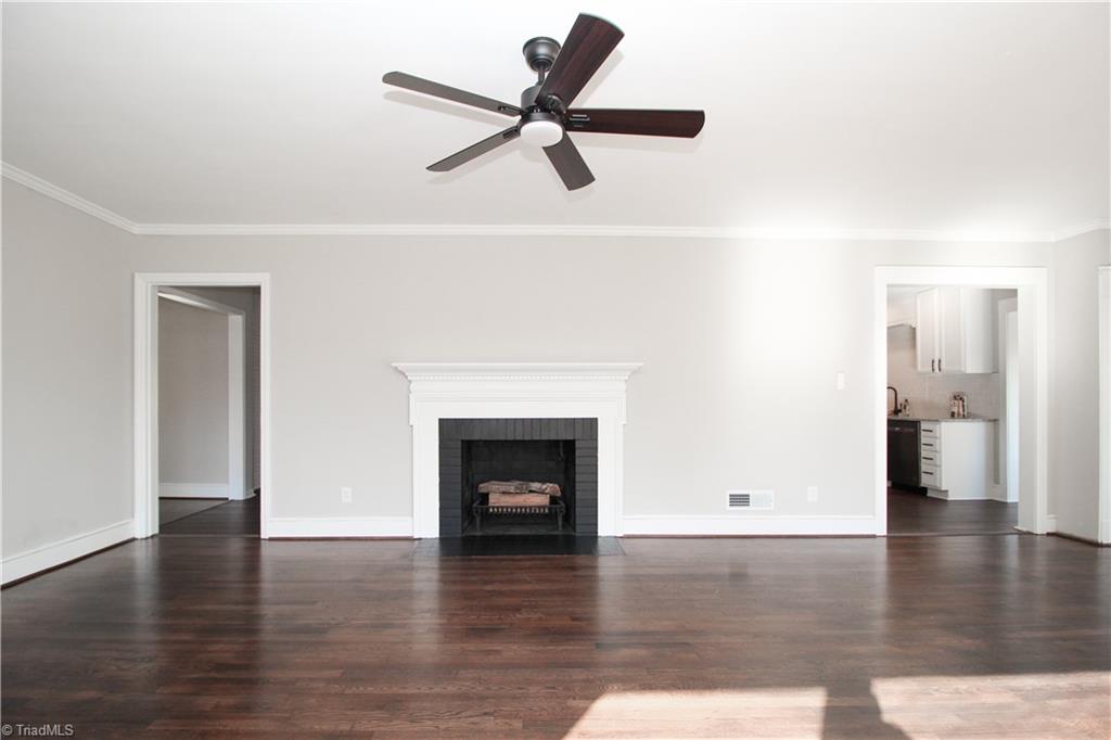 3705 Holts Chapel Road Greensboro, NC 27401 - Photo 7 of 33 Primary and second bedroom through the left, kitchen to the right