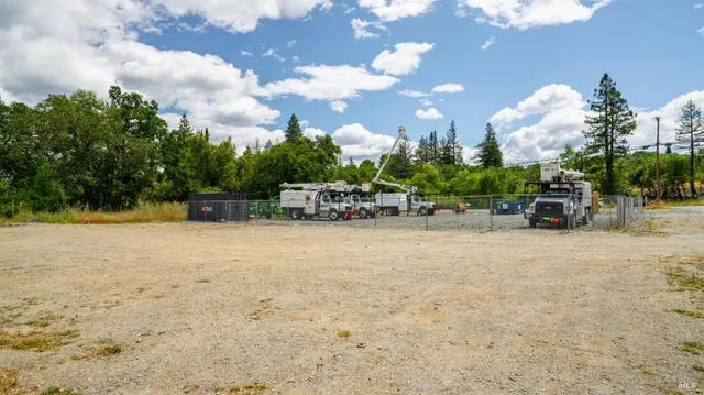 a view of a fountain with a bench in front of house