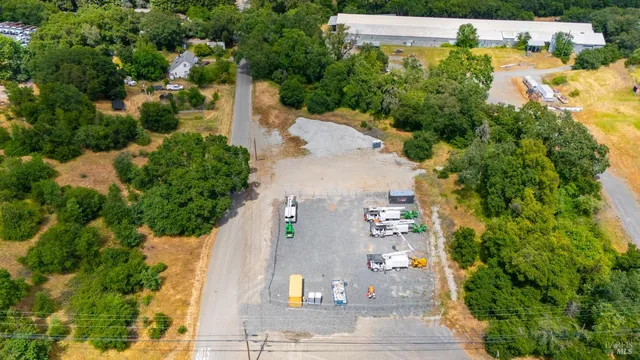 an aerial view of a house with a yard and lake view