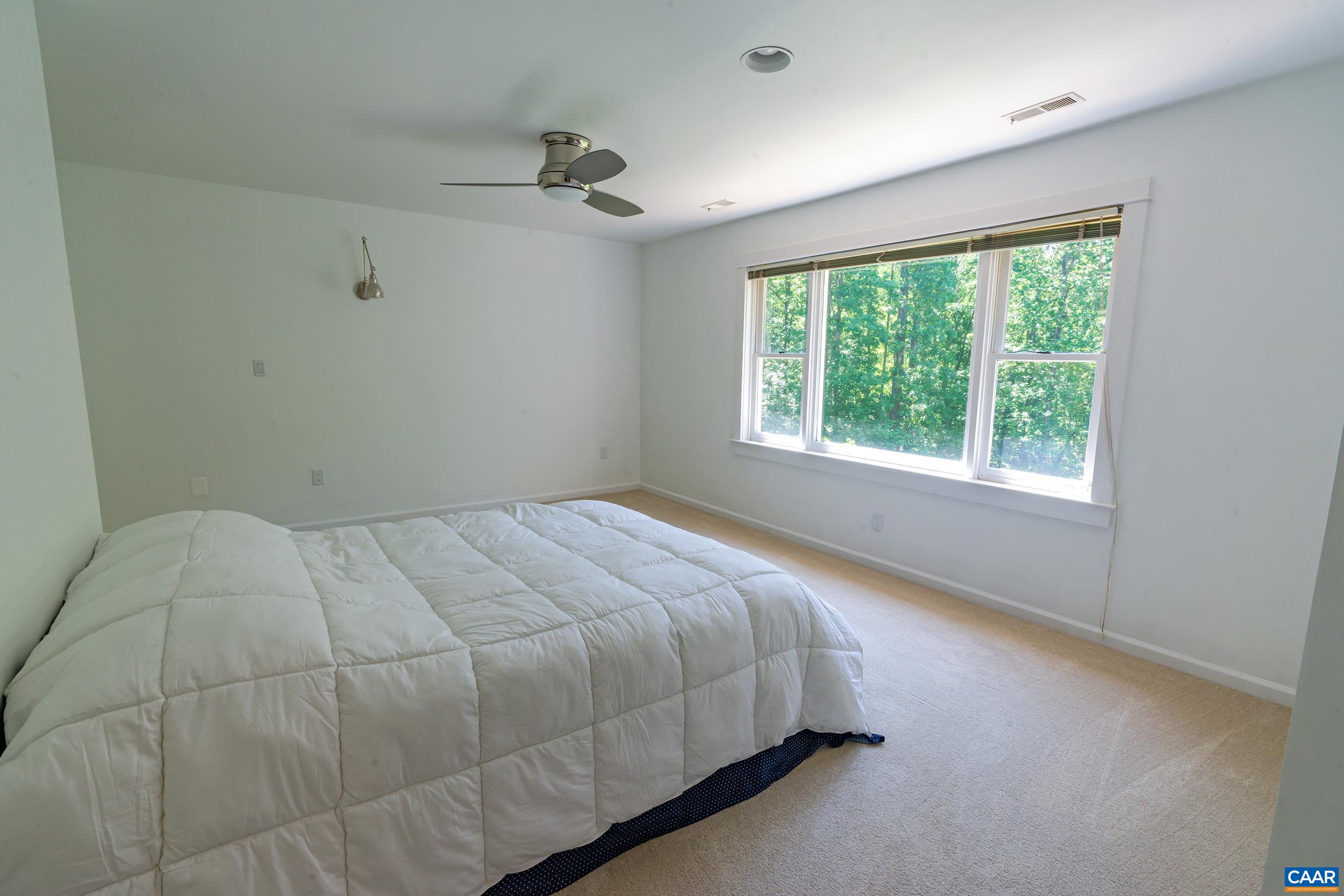 2601 Cardinal Ridge Road Charlottesville, VA 22901 - Photo 23 of 50 a bed sitting in a bedroom next to a window
