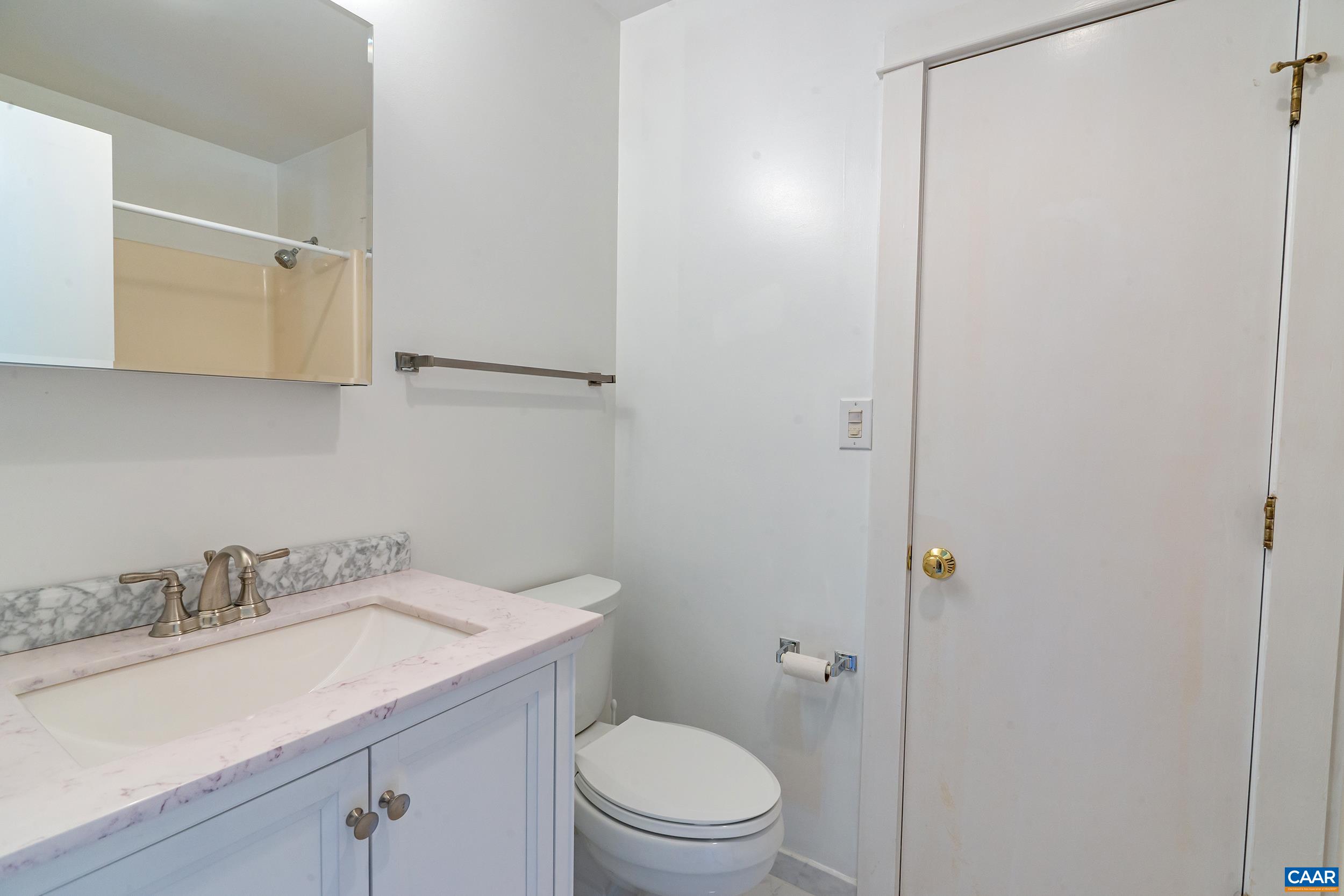 2601 Cardinal Ridge Road Charlottesville, VA 22901 - Photo 31 of 50 a bathroom with a granite countertop sink toilet and a mirror