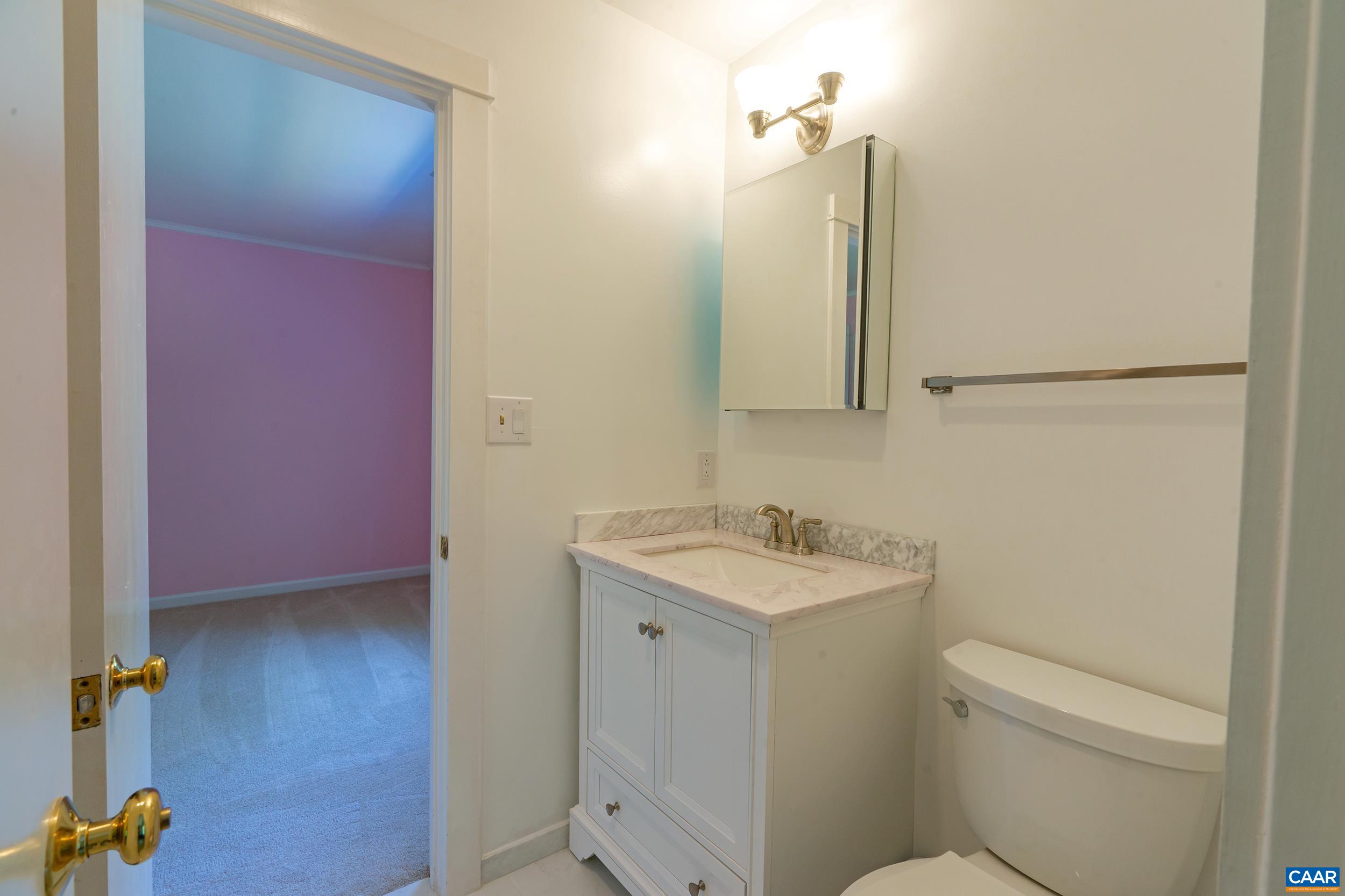 2601 Cardinal Ridge Road Charlottesville, VA 22901 - Photo 32 of 50 a bathroom with a toilet sink and mirror