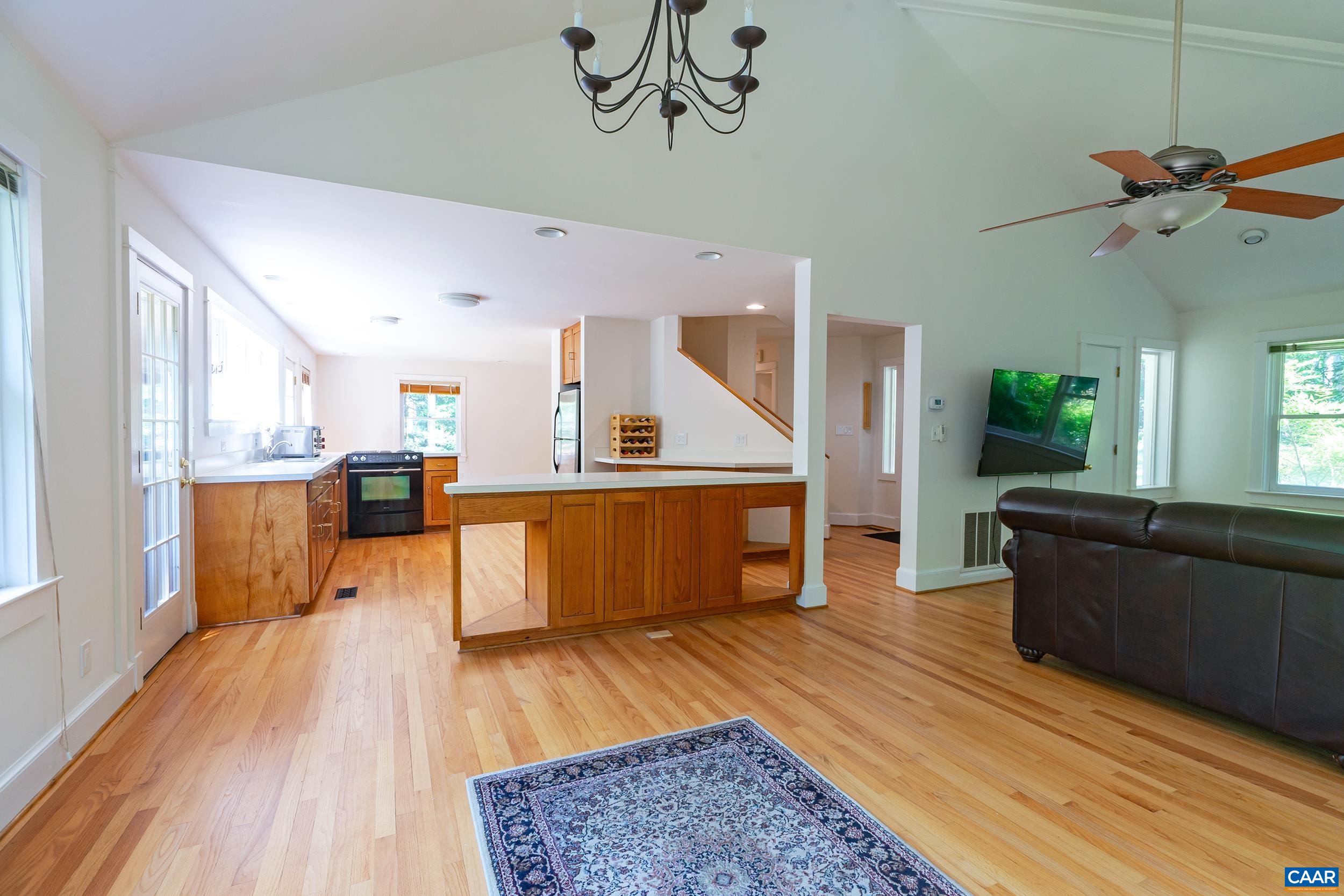 2601 Cardinal Ridge Road Charlottesville, VA 22901 - Photo 6 of 50 a living room with stainless steel appliances kitchen island granite countertop wooden floor a rug and a window