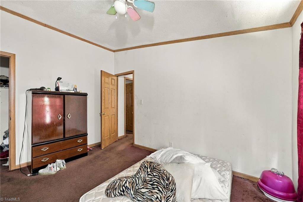 415 Talley Road Reidsville, NC 27320 - Photo 20 of 31 Third bedroom with ceiling fan and ample closet storage.