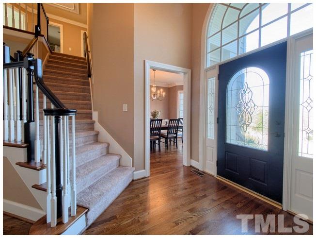 8000 Kukui Court Raleigh, NC 27613 - Photo 3 of 25 a view of a livingroom with wooden floor and stairs