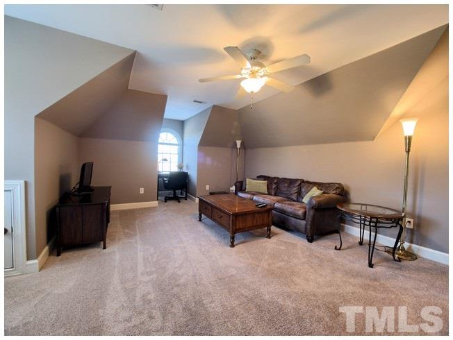 8000 Kukui Court Raleigh, NC 27613 - Photo 22 of 25 a living room with furniture and a flat screen tv