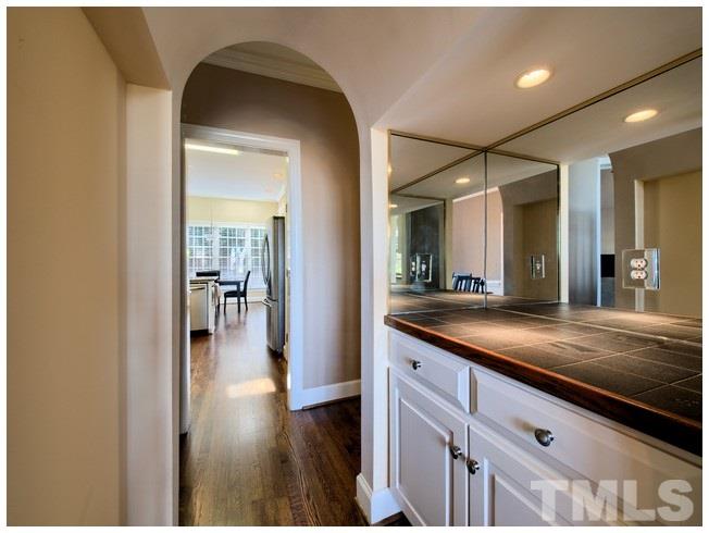8000 Kukui Court Raleigh, NC 27613 - Photo 8 of 25 a bathroom with a sink a mirror and a shower