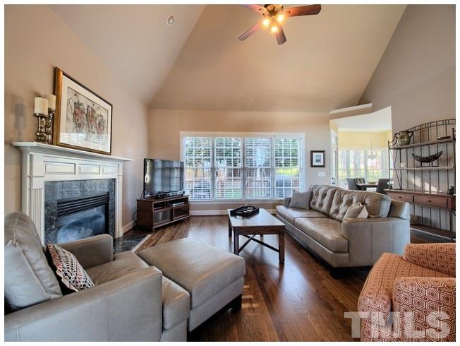 8000 Kukui Court Raleigh, NC 27613 - Photo 9 of 25 a living room with furniture and a fireplace