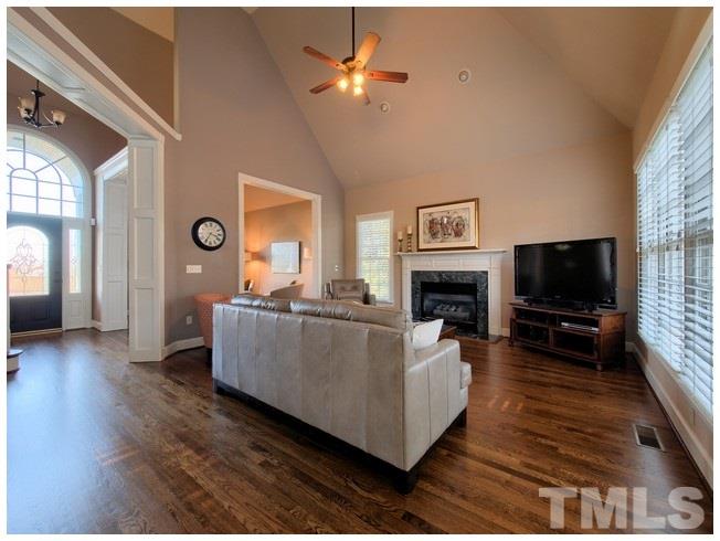 8000 Kukui Court Raleigh, NC 27613 - Photo 10 of 25 a living room with furniture and a flat screen tv