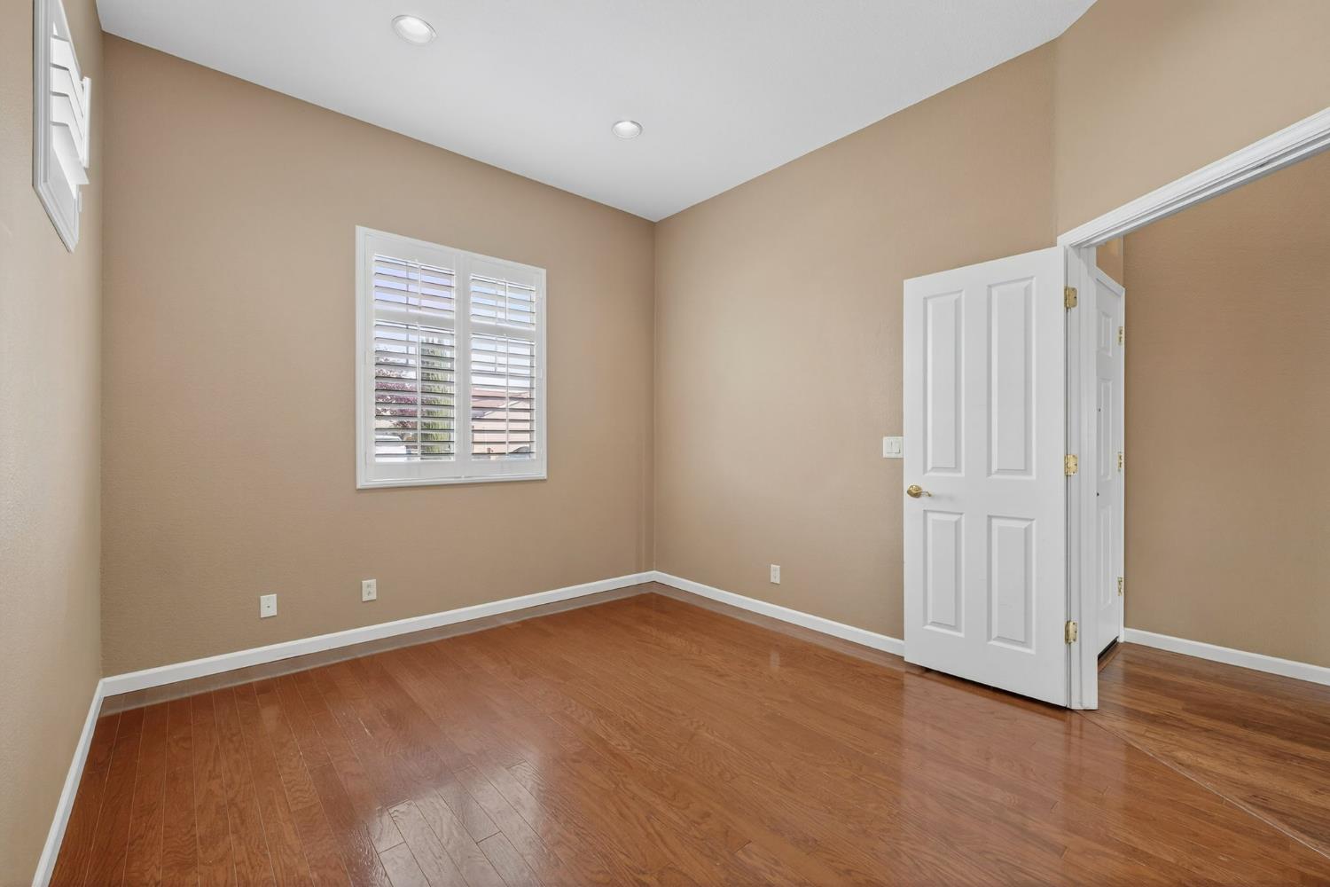 1716 Presidio Way Plumas Lake, CA 95961 - Photo 11 of 43 an empty room with wooden floor and windows