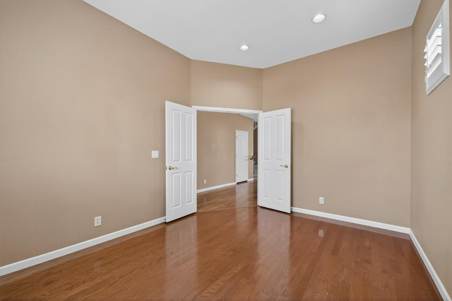 1716 Presidio Way Plumas Lake, CA 95961 - Photo 12 of 43 a view of an empty room with wooden floor and a window