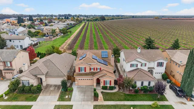 an aerial view of multiple houses with a yard