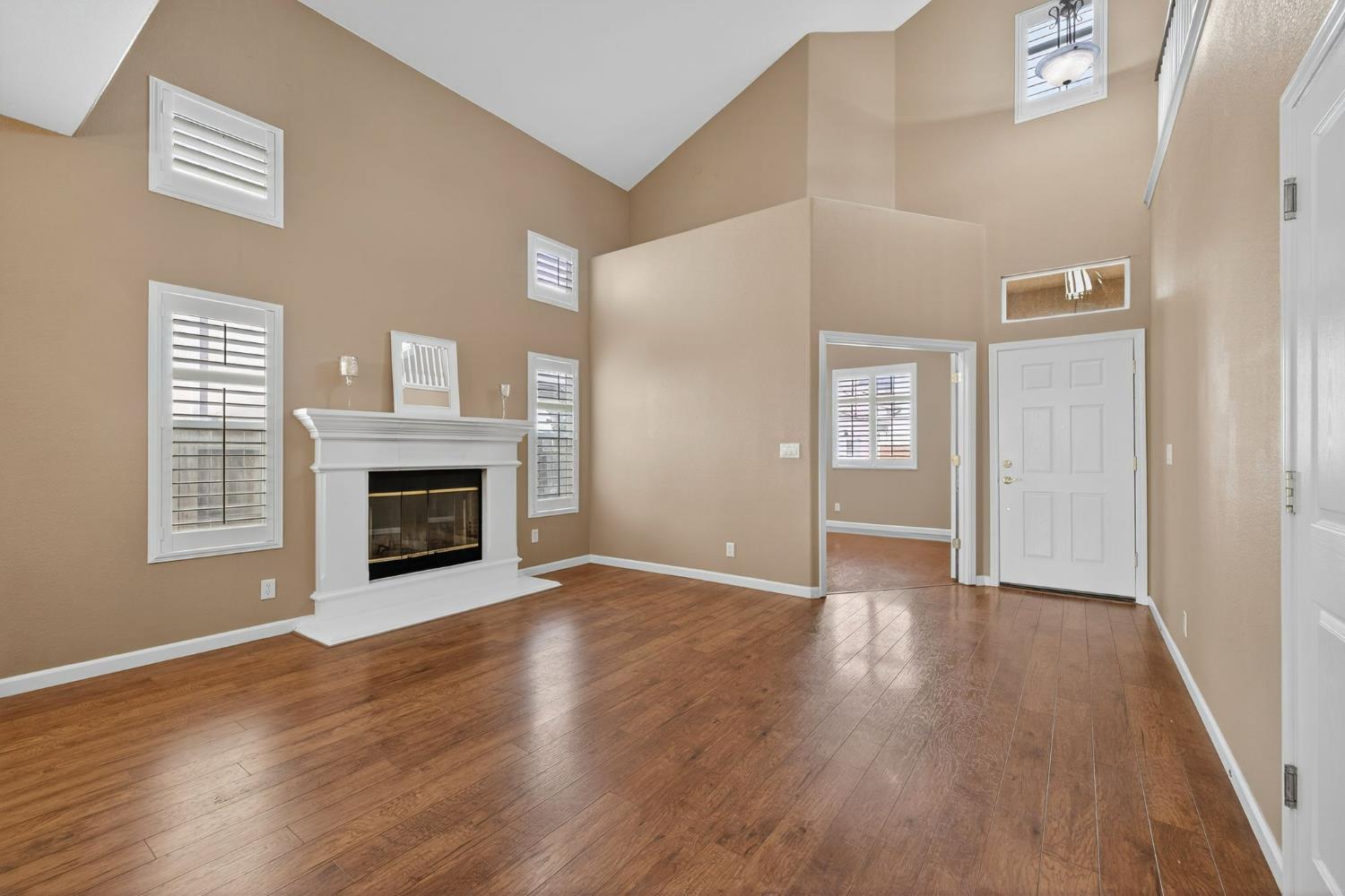 1716 Presidio Way Plumas Lake, CA 95961 - Photo 5 of 43 a view of an empty room with wooden floor fireplace and a window