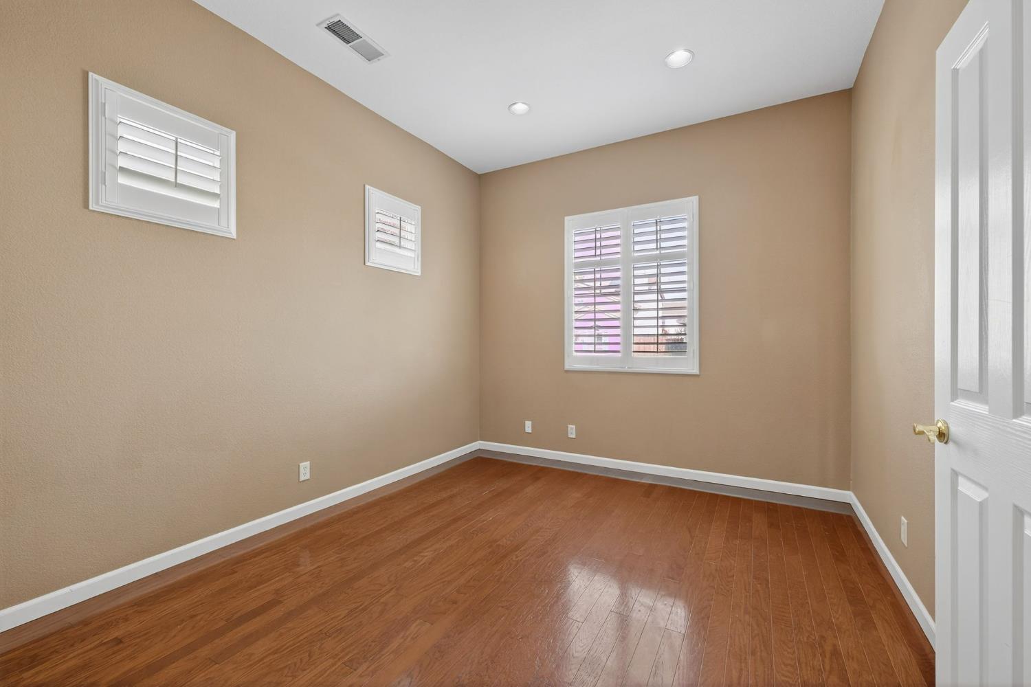 1716 Presidio Way Plumas Lake, CA 95961 - Photo 10 of 43 a view of an empty room with wooden floor and a window