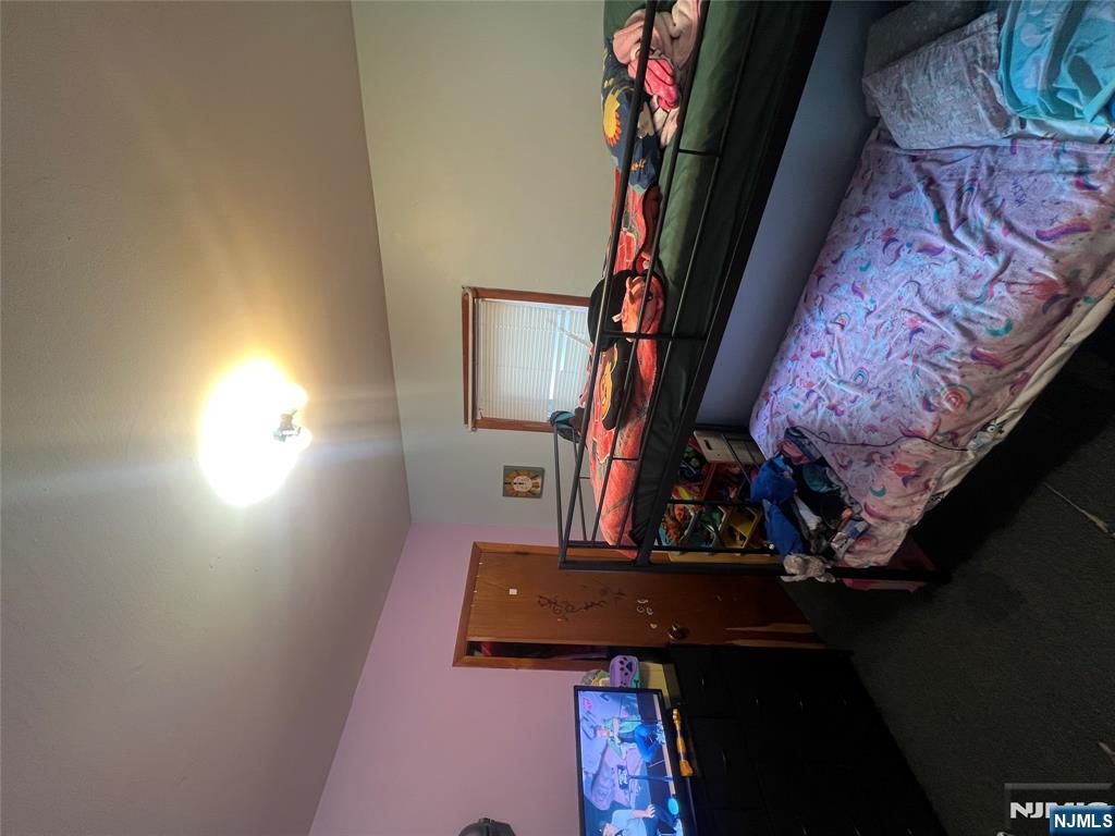 68 Atlantic Street Carteret, NJ 07008 - Photo 22 of 38 a bed room with a bed and a fireplace