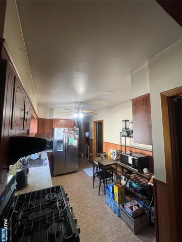 a bed sitting in a bedroom next to a larger window