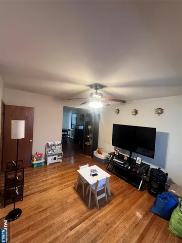 a room with pool table flat screen tv and windows