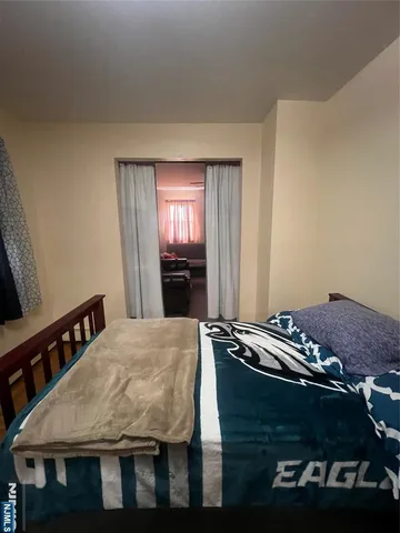 a room with furniture a flat screen tv and a refrigerator