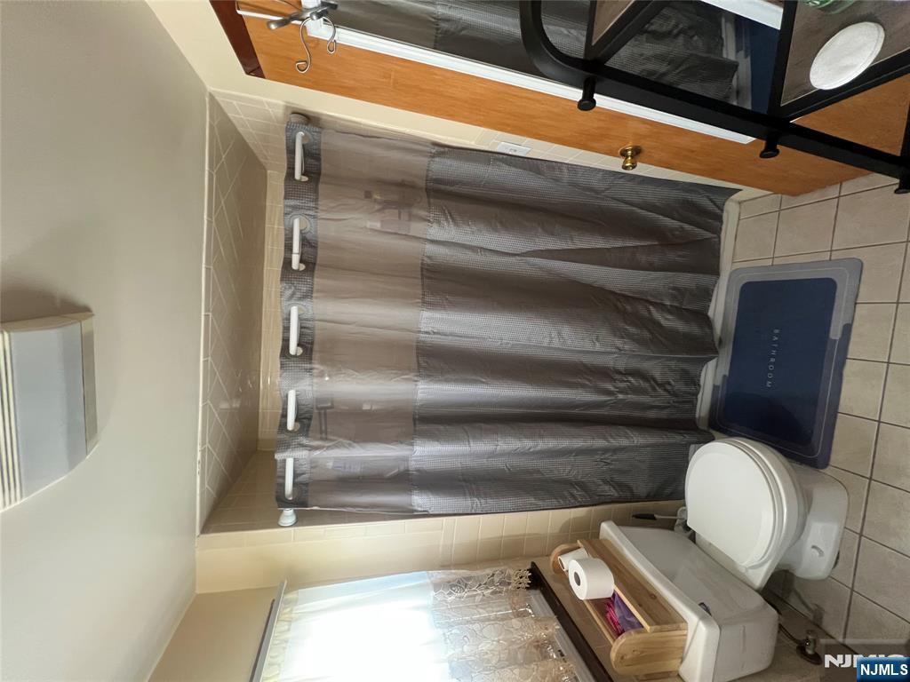 68 Atlantic Street Carteret, NJ 07008 - Photo 31 of 38 a bathroom with a toilet and a shower
