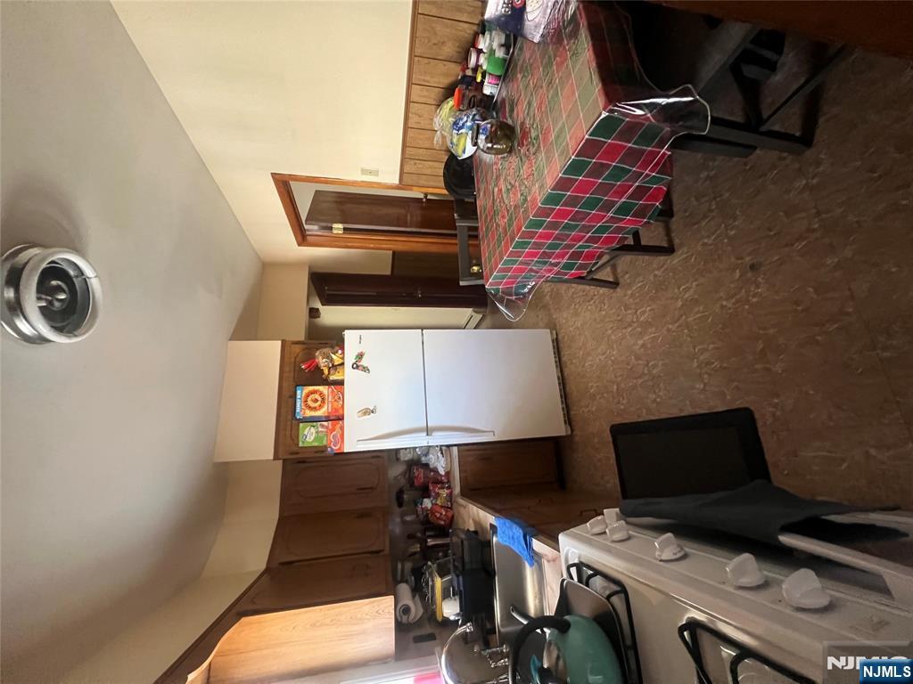 68 Atlantic Street Carteret, NJ 07008 - Photo 32 of 38 a room with furniture a flat screen tv and a refrigerator