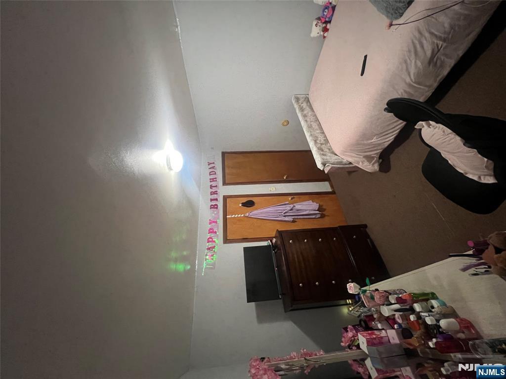 68 Atlantic Street Carteret, NJ 07008 - Photo 37 of 38 a bedroom with a bed and a dresser