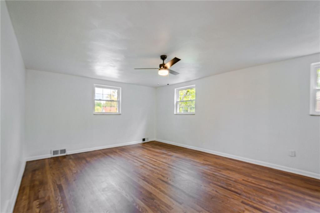 1611 Branning Road Pittsburgh, PA 15235 - Photo 24 of 38 an empty room with a window and wooden floor