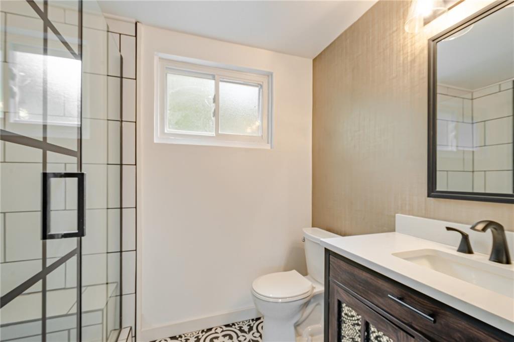 1611 Branning Road Pittsburgh, PA 15235 - Photo 28 of 38 a bathroom with a granite countertop sink toilet and mirror