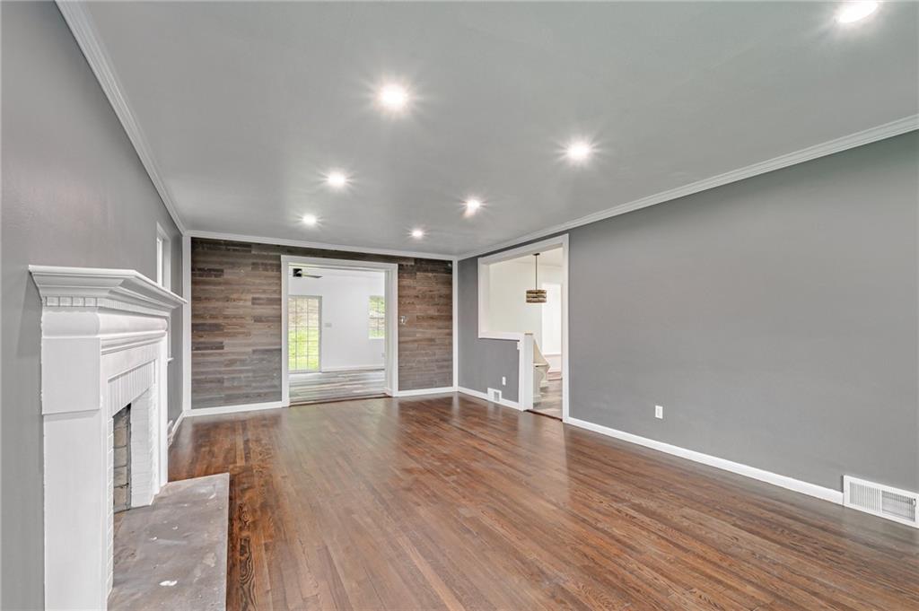1611 Branning Road Pittsburgh, PA 15235 - Photo 5 of 38 a view of an empty room with wooden floor and a fireplace