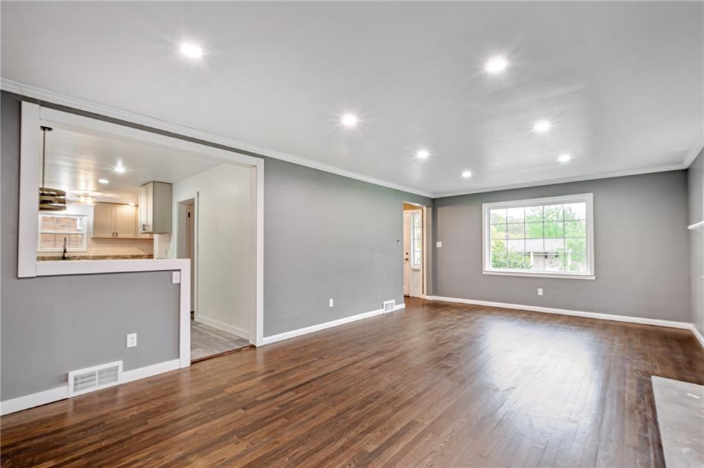 1611 Branning Road Pittsburgh, PA 15235 - Photo 6 of 38 a view of an empty room with wooden floor and a window