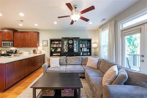 a living room with furniture and a bookshelf