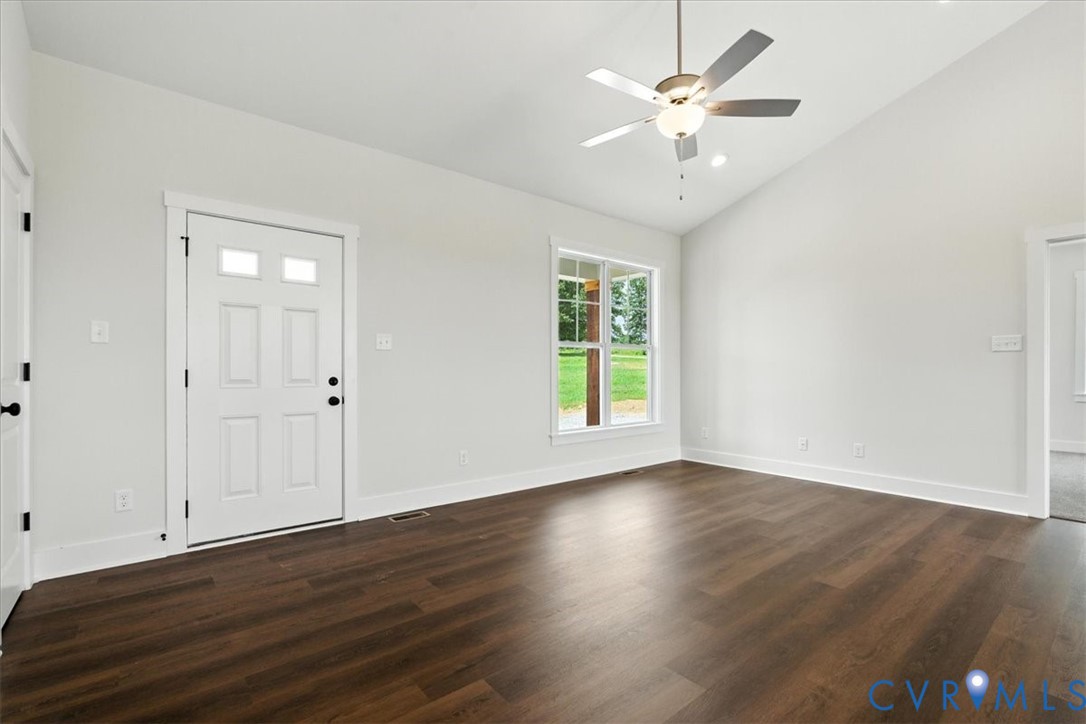 8666 Hat Creek Road Brookneal, VA 24528 - Photo 13 of 38 an empty room with wooden floor and ceiling fan