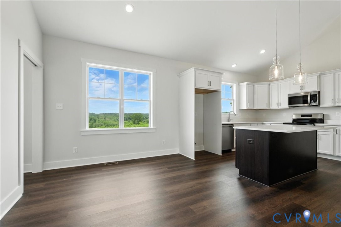 8666 Hat Creek Road Brookneal, VA 24528 - Photo 16 of 38 a kitchen with stainless steel appliances granite countertop a stove a sink and a microwave