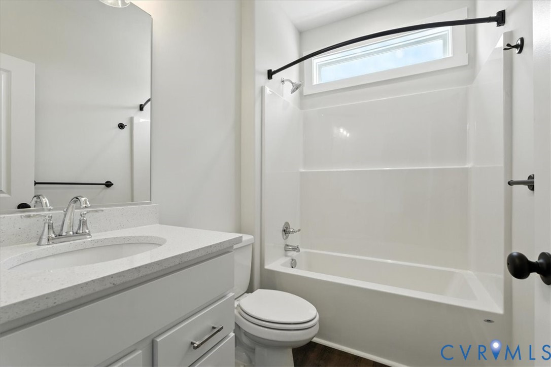 8666 Hat Creek Road Brookneal, VA 24528 - Photo 26 of 38 a bathroom with a sink a toilet and a mirror