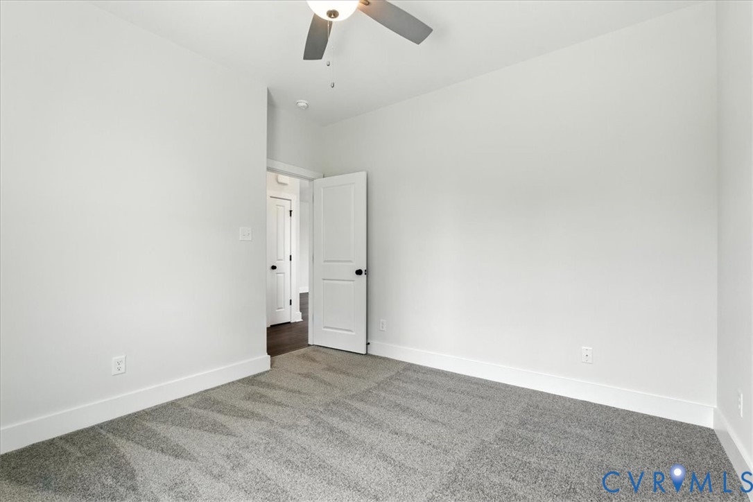 8666 Hat Creek Road Brookneal, VA 24528 - Photo 28 of 38 an empty room with an entryway and chandelier