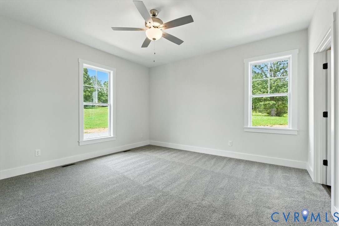 8666 Hat Creek Road Brookneal, VA 24528 - Photo 32 of 38 an empty room with a window and a fan
