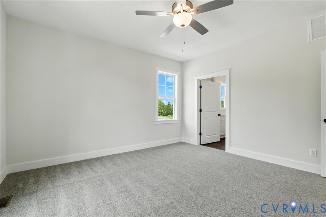 8666 Hat Creek Road Brookneal, VA 24528 - Photo 33 of 38 an empty room with a window and a fan
