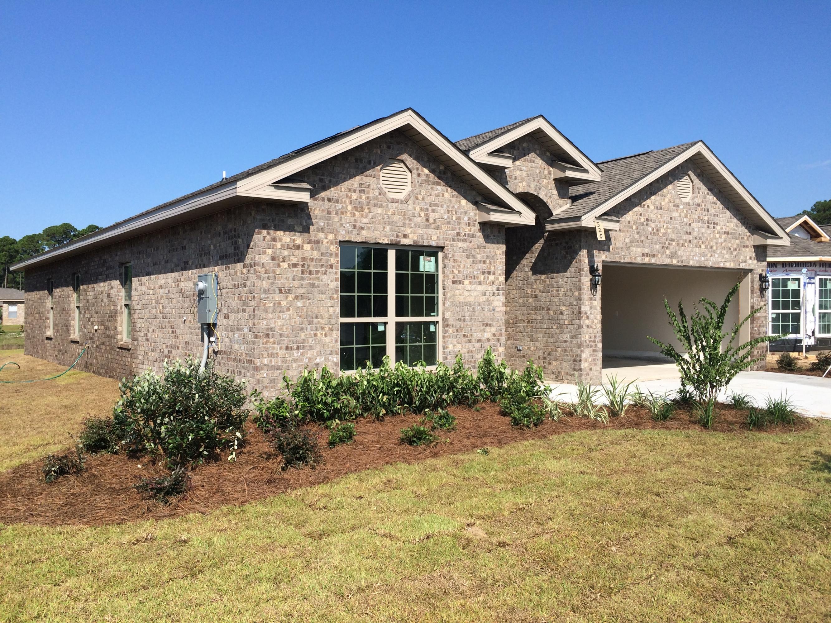 389 Pin Oak Loop Santa Rosa Beach, FL 32459 - Photo 2 of 19 a front view of a house with a yard